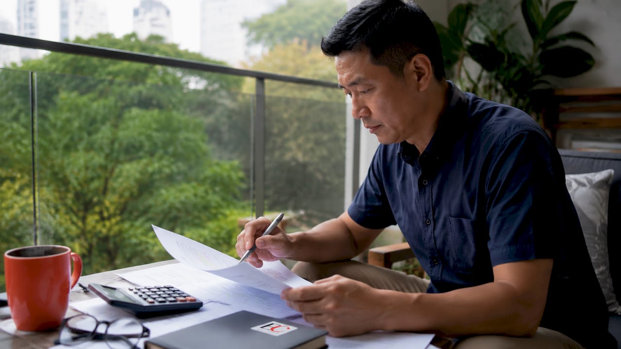 Buying property in Singapore: 2026 complete guide 1 Buyer checking property financing documents