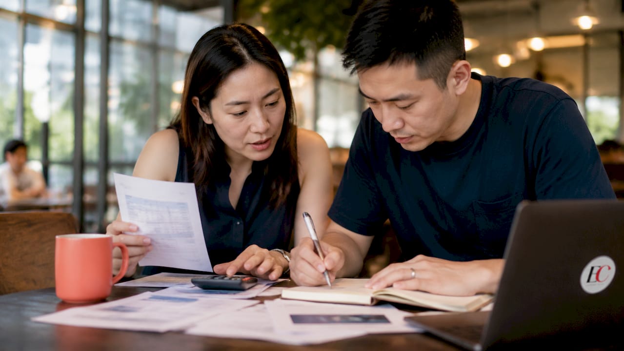 Why create a family budget: your 2026 singapore guide 1 Singaporean couple budgeting at home dining table