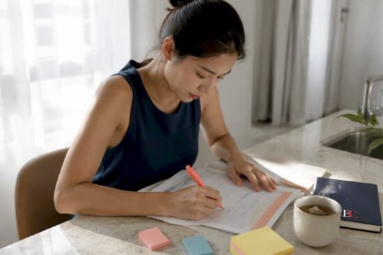 Young woman budgeting at home table