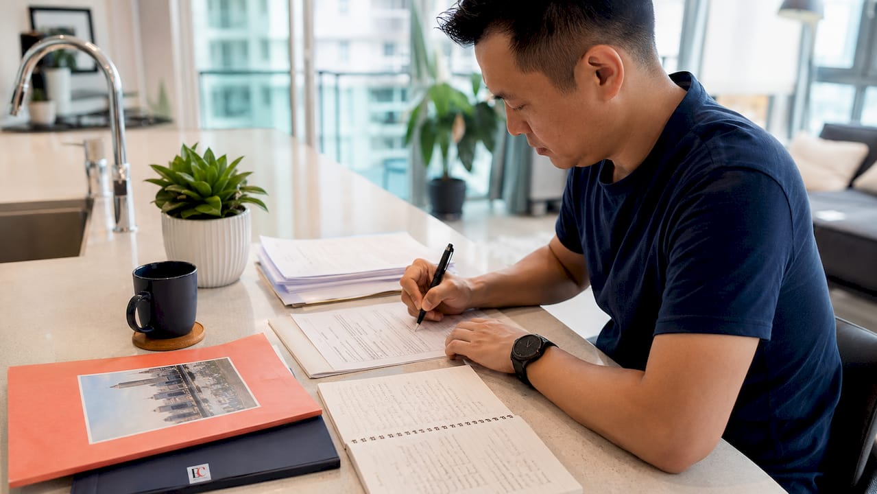 Singapore stock market investing basics: 2026 guide 1 Man opening CDP account application at home