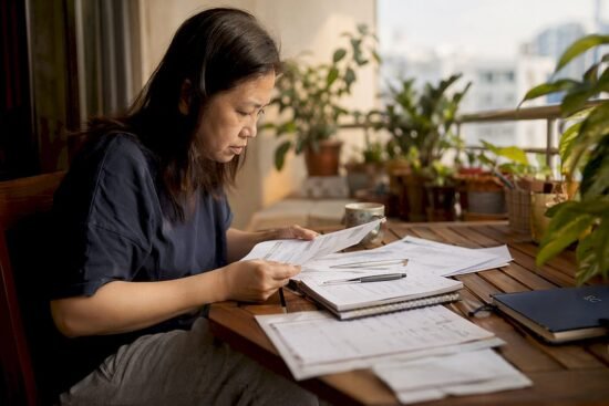 Woman budgeting household expenses at home